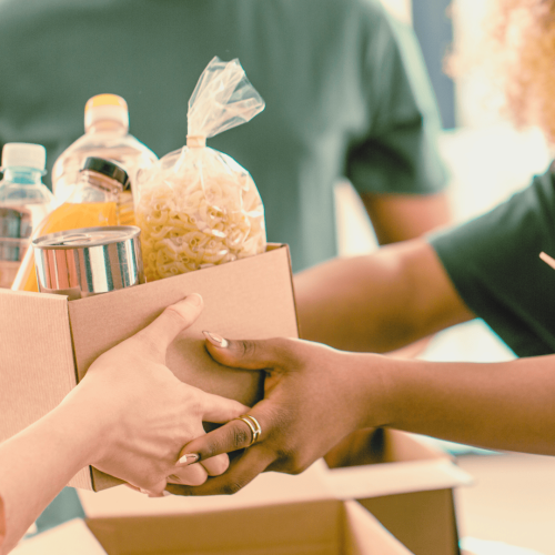 Woman handing over a food donation box
