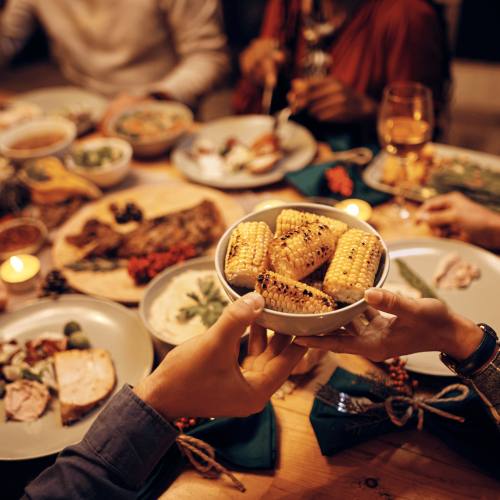 People enjoying a large meal together at night.