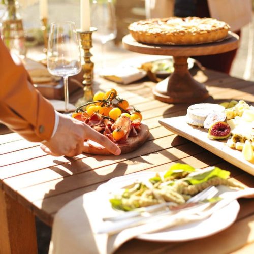 A woman setting down a plate with fruits on it