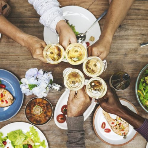 People sharing food and drinks at a table